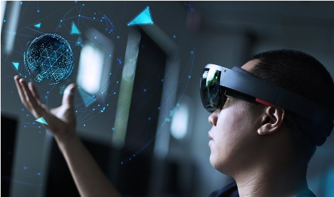 Man holds simulated image in his hands while wearing AR/VR headset